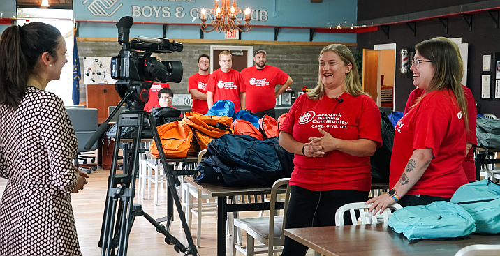 news crew filming volunteers